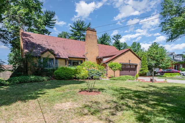 1107 Covedale Ave, Cincinnati, OH 45238 - view of front facade featuring an attached garage, a front yard, a chimney, driveway, and brick siding