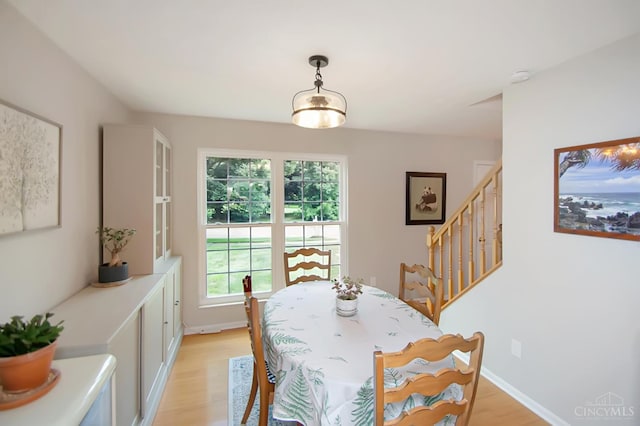 6711 Bayberry Ct, Hamilton Twp, OH 45039 - dining room featuring light wood-style flooring and stairway