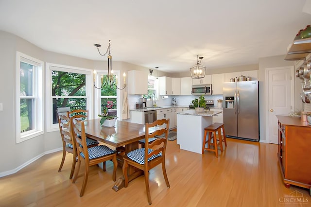 6711 Bayberry Ct, Hamilton Twp, OH 45039 - dining space featuring light wood-style floors and a chandelier