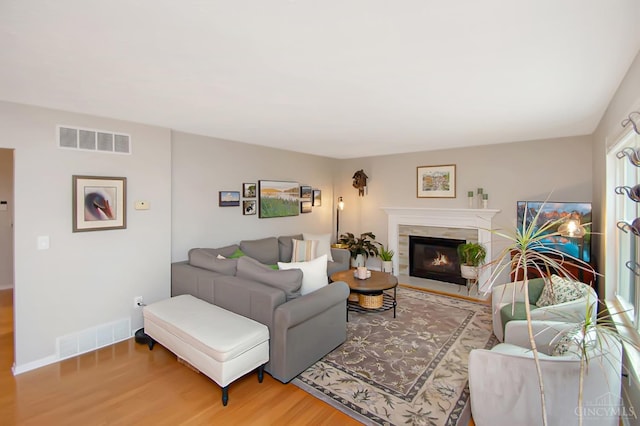 6711 Bayberry Ct, Hamilton Twp, OH 45039 - living room with wood finished floors and a fireplace with flush hearth