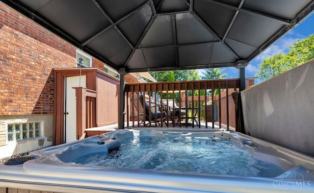 5817 Countryview Ter, Delhi Twp, OH 45233 - wooden deck with a hot tub and a storage unit
