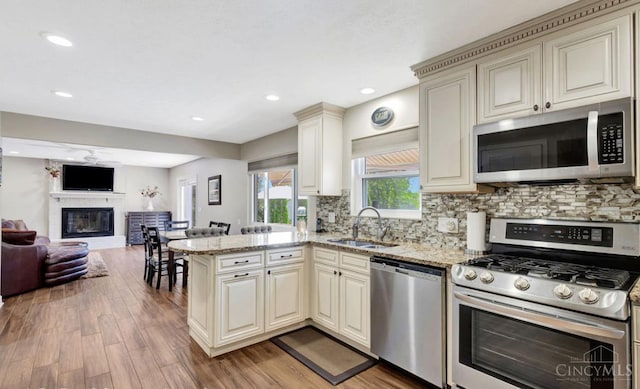 5817 Countryview Ter, Delhi Twp, OH 45233 - kitchen with appliances with stainless steel finishes, cream cabinetry, light wood-style floors, and recessed lighting