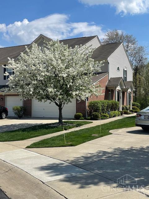 9530 Greenery Ct, Deerfield Twp, OH 45140 - view of front of home with brick siding, driveway, and a garage