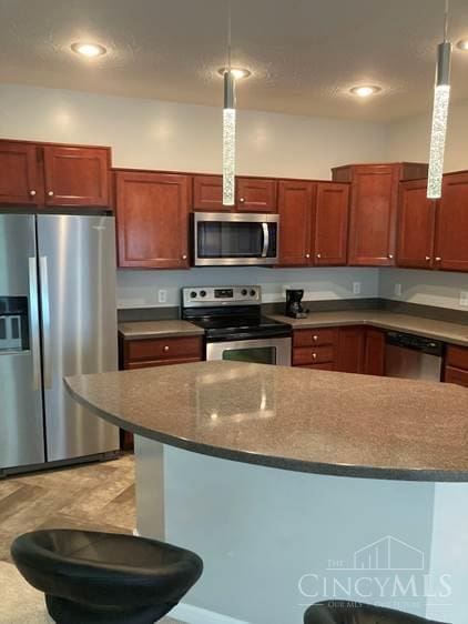 9530 Greenery Ct, Deerfield Twp, OH 45140 - kitchen featuring appliances with stainless steel finishes and pendant lighting