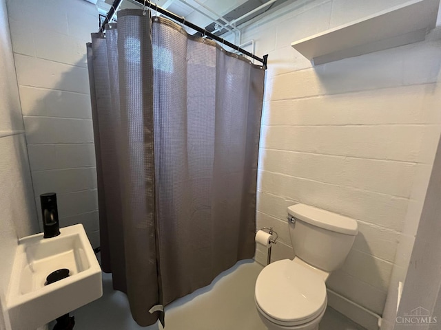 2035 Miles Rd, Cincinnati, OH 45231 - bathroom featuring concrete block wall and shower / bath combination with curtain