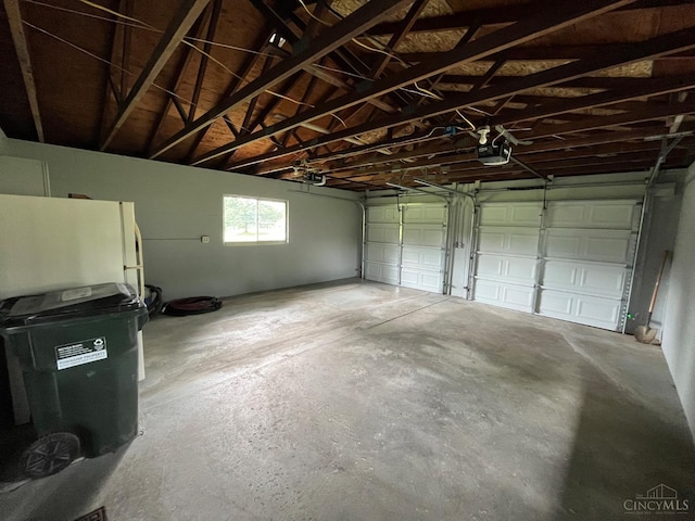 2035 Miles Rd, Cincinnati, OH 45231 - garage featuring freestanding refrigerator and a garage door opener