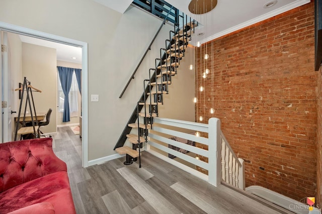 2711 Price Ave, Cincinnati, OH 45204 - staircase with brick wall and wood finished floors