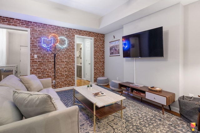 2711 Price Ave, Cincinnati, OH 45204 - living room with brick wall, an accent wall, and wood finished floors