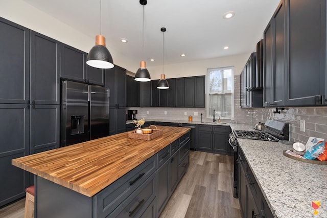 2711 Price Ave, Cincinnati, OH 45204 - kitchen featuring stainless steel appliances, wooden counters, tasteful backsplash, light wood-style flooring, and recessed lighting