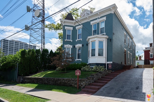 2711 Price Ave, Cincinnati, OH 45204 - italianate house featuring brick siding, a front yard, and driveway