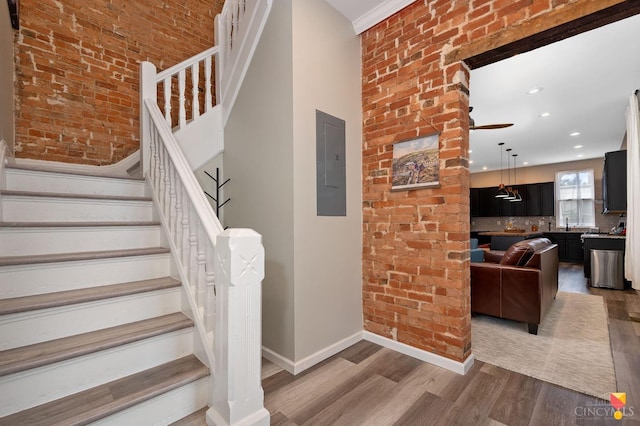2711 Price Ave, Cincinnati, OH 45204 - stairway featuring electric panel, wood finished floors, ceiling fan, and recessed lighting