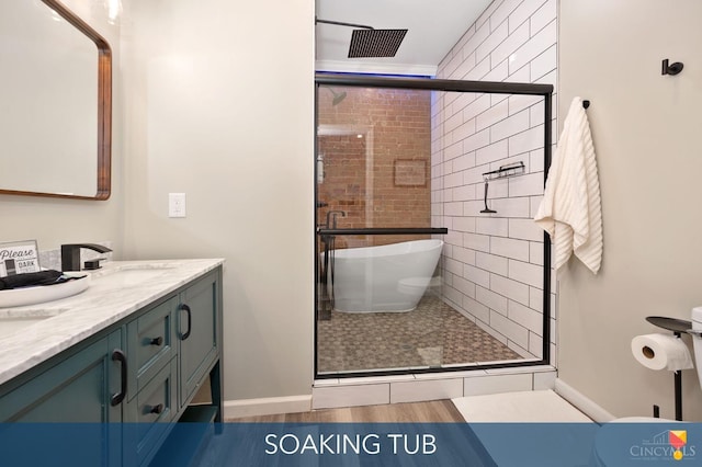 2711 Price Ave, Cincinnati, OH 45204 - full bathroom with double vanity, a stall shower, and a freestanding tub