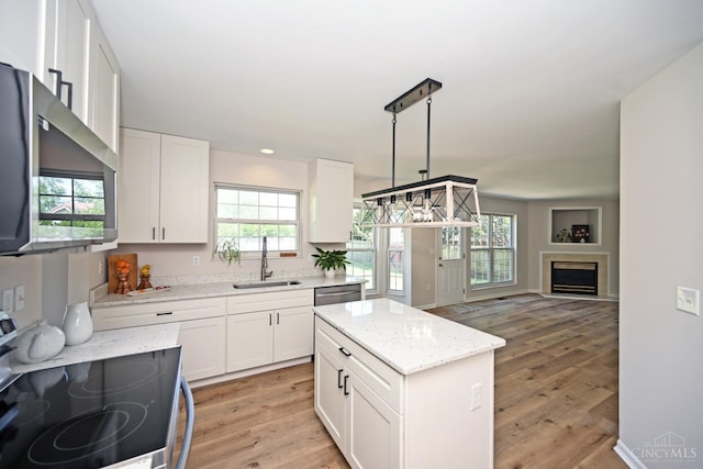 1055 Valley Wood Dr, Union Twp, OH 45103 - kitchen with stainless steel appliances, white cabinetry, light wood-style flooring, light stone countertops, and recessed lighting