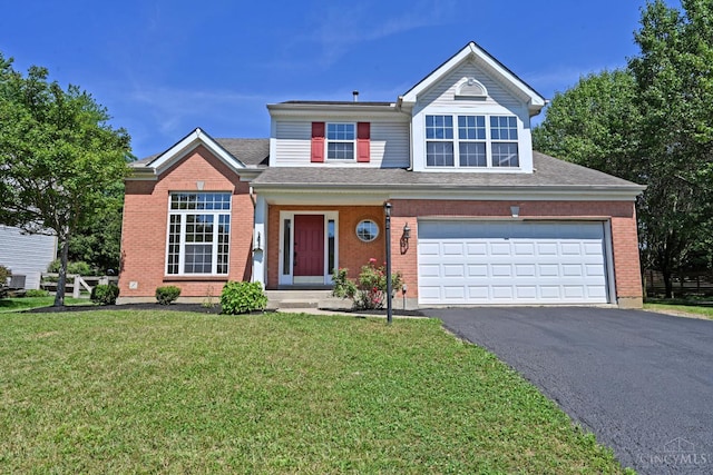 1055 Valley Wood Dr, Union Twp, OH 45103 - traditional-style home with driveway, an attached garage, a front lawn, and brick siding