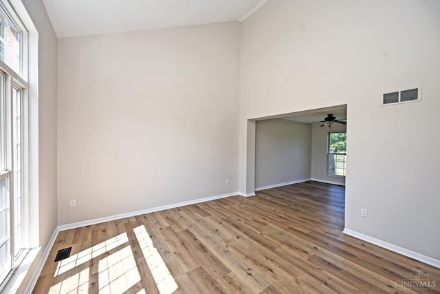 1055 Valley Wood Dr, Union Twp, OH 45103 - spare room featuring wood finished floors, high vaulted ceiling, and ceiling fan