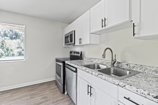 2016 Mistyhill Dr, Springfield Twp, OH 45240 - kitchen with stainless steel appliances, white cabinets, and light wood-style flooring