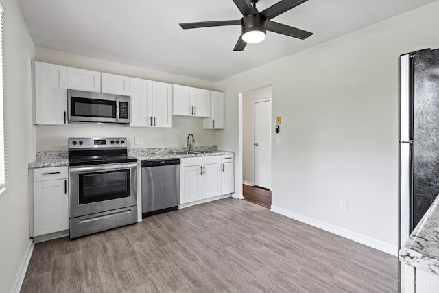 2016 Mistyhill Dr, Springfield Twp, OH 45240 - kitchen with stainless steel appliances, a ceiling fan, white cabinets, and light wood-type flooring