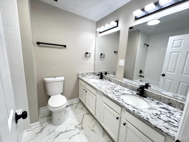 176 Lakeview Dr, Monroe, OH 45044 - full bathroom featuring double vanity, marble finish floors, a textured ceiling, and shower / bathtub combination
