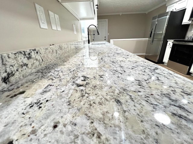 176 Lakeview Dr, Monroe, OH 45044 - kitchen featuring stainless steel range with electric cooktop, ornamental molding, white cabinetry, and light stone countertops