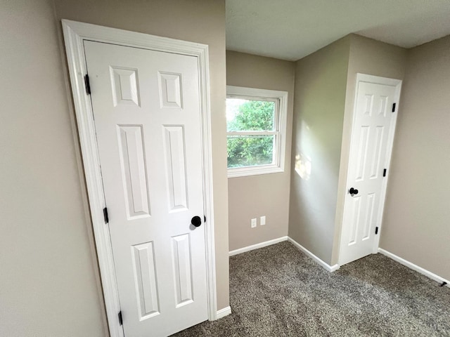 176 Lakeview Dr, Monroe, OH 45044 - unfurnished bedroom with baseboards and dark carpet