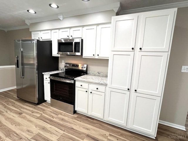 176 Lakeview Dr, Monroe, OH 45044 - kitchen featuring appliances with stainless steel finishes, ornamental molding, white cabinets, light wood finished floors, and light stone counters