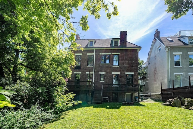 2153 Sinton Ave, Cincinnati, OH 45206 - back of house with stairway, a lawn, brick siding, a chimney, and a wooden deck