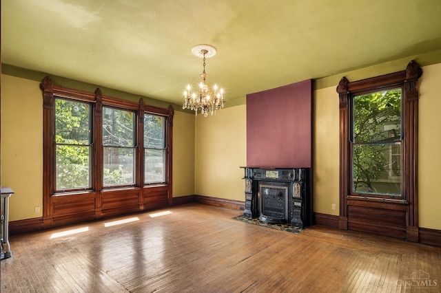 2153 Sinton Ave, Cincinnati, OH 45206 - unfurnished living room with a chandelier, wood-type flooring, and a fireplace with flush hearth