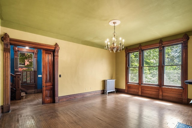 2153 Sinton Ave, Cincinnati, OH 45206 - empty room with radiator, a chandelier, and wood finished floors