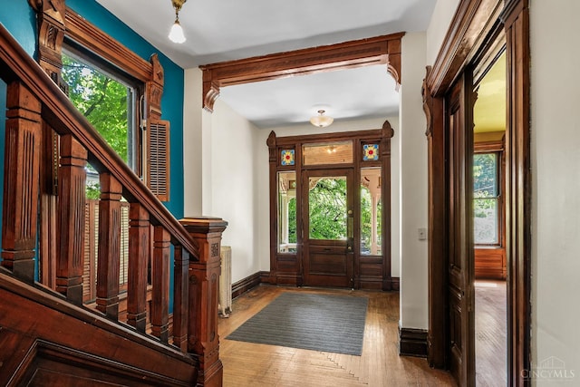 2153 Sinton Ave, Cincinnati, OH 45206 - foyer entrance with healthy amount of natural light, stairs, and wood finished floors