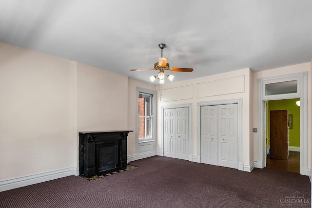 2153 Sinton Ave, Cincinnati, OH 45206 - unfurnished living room with dark carpet, a ceiling fan, and a fireplace with flush hearth