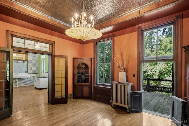 2153 Sinton Ave, Cincinnati, OH 45206 - office space featuring an ornate ceiling, a chandelier, wood finished floors, and a raised ceiling