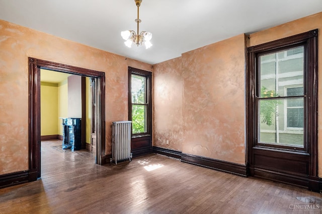 2153 Sinton Ave, Cincinnati, OH 45206 - spare room with radiator heating unit, wood finished floors, and a chandelier