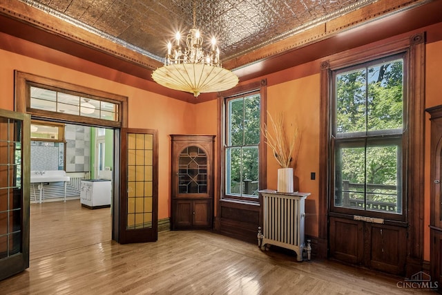 2153 Sinton Ave, Cincinnati, OH 45206 - home office with an ornate ceiling, a chandelier, wood finished floors, and radiator heating unit