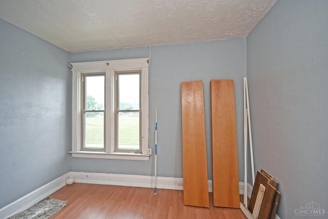 1319 Jefferson Ave, Reading, OH 45215 - unfurnished bedroom featuring a textured ceiling and wood finished floors