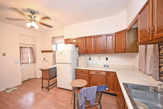 1319 Jefferson Ave, Reading, OH 45215 - kitchen with freestanding refrigerator, ceiling fan, brown cabinets, and light countertops