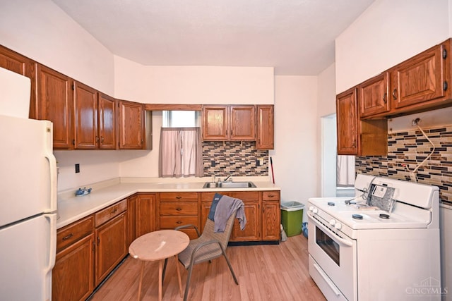 1319 Jefferson Ave, Reading, OH 45215 - kitchen featuring white appliances, washer / dryer, tasteful backsplash, light wood-style floors, and light countertops