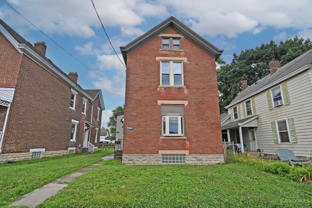 1319 Jefferson Ave, Reading, OH 45215 - rear view of property featuring brick siding and a yard