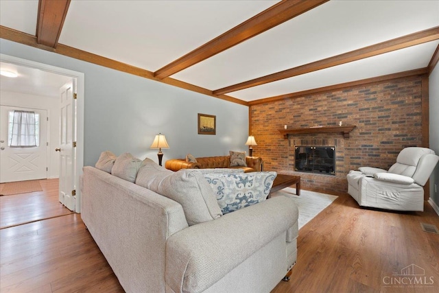 5577 Dove Ln, West Chester, OH 45069 - living area with beamed ceiling, wood finished floors, and a brick fireplace