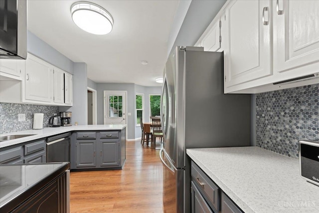 5577 Dove Ln, West Chester, OH 45069 - kitchen featuring dishwasher, gray cabinetry, white cabinets, light wood-type flooring, and backsplash