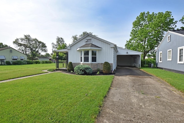 1008 Garden Ave, Middletown, OH 45044 - view of front of home with an attached carport, driveway, a front yard, and board and batten siding