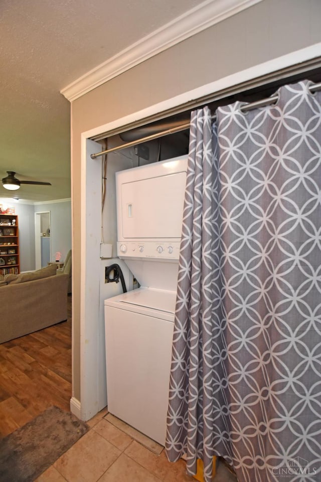 1008 Garden Ave, Middletown, OH 45044 - laundry area featuring stacked washer / drying machine, crown molding, light tile patterned floors, and ceiling fan