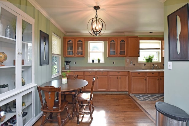 1008 Garden Ave, Middletown, OH 45044 - kitchen with a chandelier, crown molding, light countertops, and glass insert cabinets