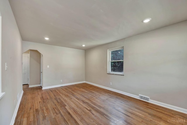 7866 Stillwell Rd, Cincinnati, OH 45237 - empty room with arched walkways, wood finished floors, and recessed lighting