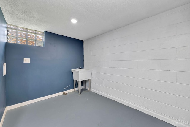 7866 Stillwell Rd, Cincinnati, OH 45237 - unfurnished room featuring finished concrete floors, a textured ceiling, and concrete block wall