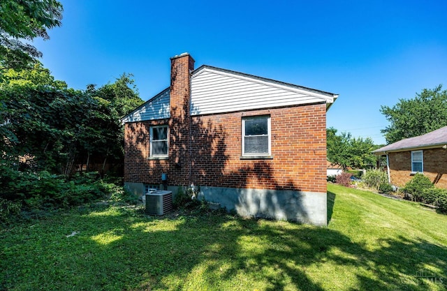 7866 Stillwell Rd, Cincinnati, OH 45237 - view of property exterior with a chimney, a yard, and brick siding