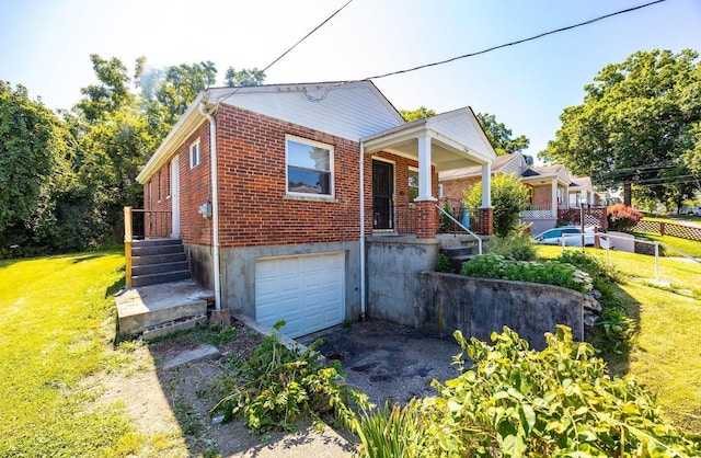 7866 Stillwell Rd, Cincinnati, OH 45237 - bungalow-style house featuring brick siding, a garage, driveway, a front lawn, and covered porch