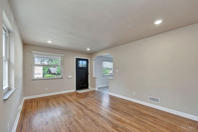 7866 Stillwell Rd, Cincinnati, OH 45237 - foyer entrance with arched walkways, light wood-style flooring, and recessed lighting