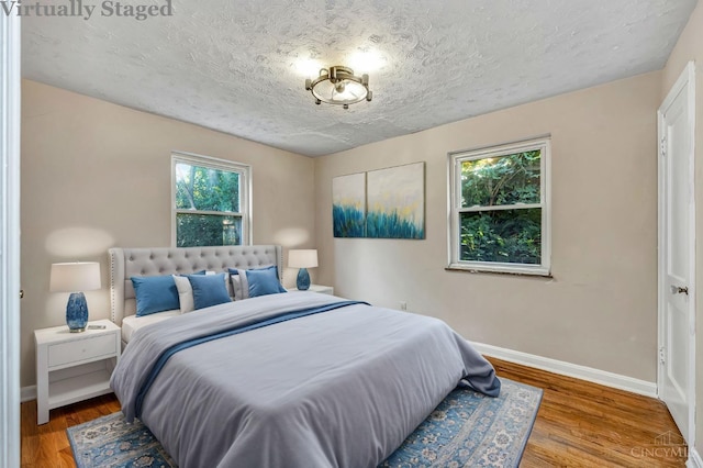 7866 Stillwell Rd, Cincinnati, OH 45237 - bedroom with a textured ceiling and wood finished floors