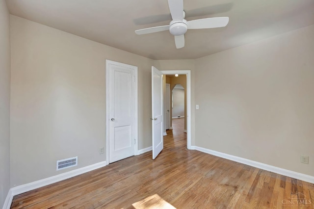7866 Stillwell Rd, Cincinnati, OH 45237 - empty room with a ceiling fan, light wood-style flooring, and arched walkways