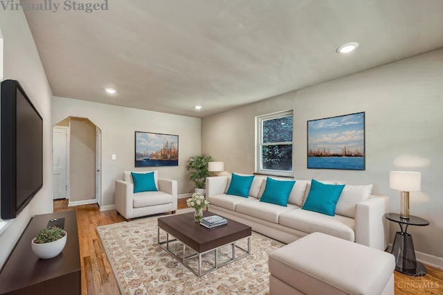 7866 Stillwell Rd, Cincinnati, OH 45237 - living room with wood finished floors, recessed lighting, and arched walkways
